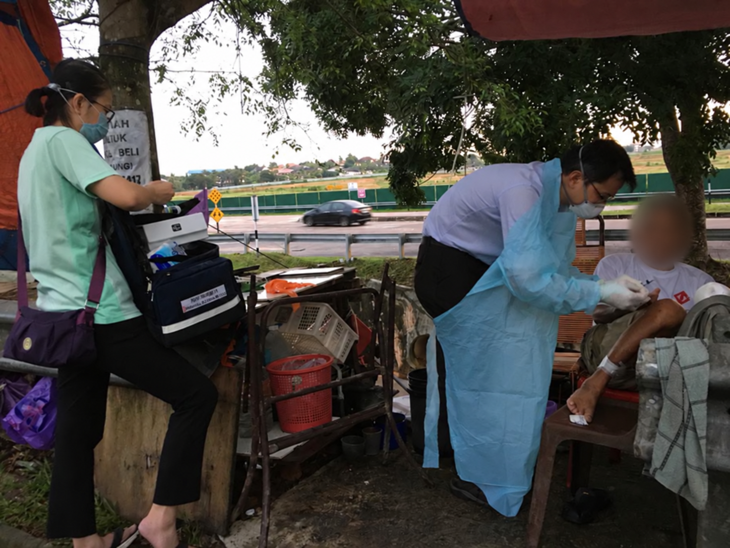 Community medical visit with the patient’s face blurred
